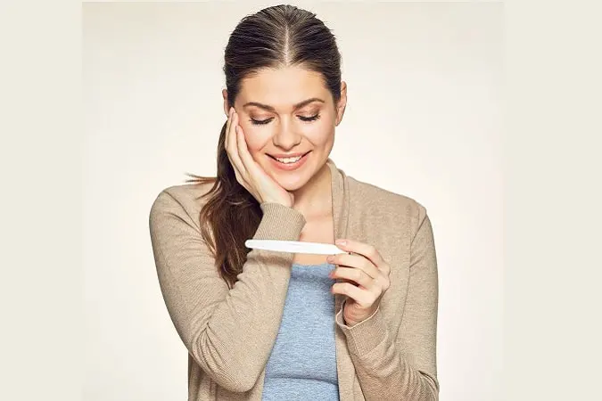 Smiling,Woman,Looking,On,Pregnant,Test.,Isolated,Portrait,Of,Young