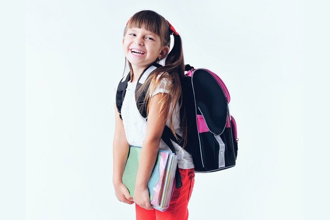 Portrait,Of,Teenager,Girl,With,School,Backpack,Holding,Colored,Folders