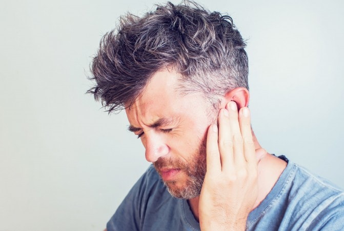 man-with-earache-is-holding-his-aching-ear-body-royalty-free-image-1604596031_.jpg